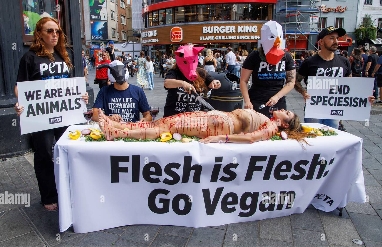 london-uk-27th-aug-2022-peta-protest-in-leicester-square-world-day-for-the-end-of-speciesism-27-august-when-a-trio-of-protesters-dressed-as-animals-dine-on-a-blood-smeared-human-in-londons-leicester-square-the-lunch-in-is-part-of-petas-effo.jpg